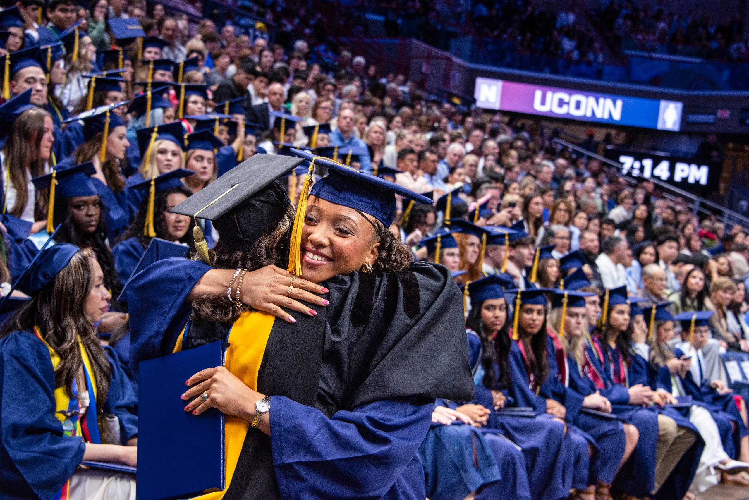 graduates hugging at commencement