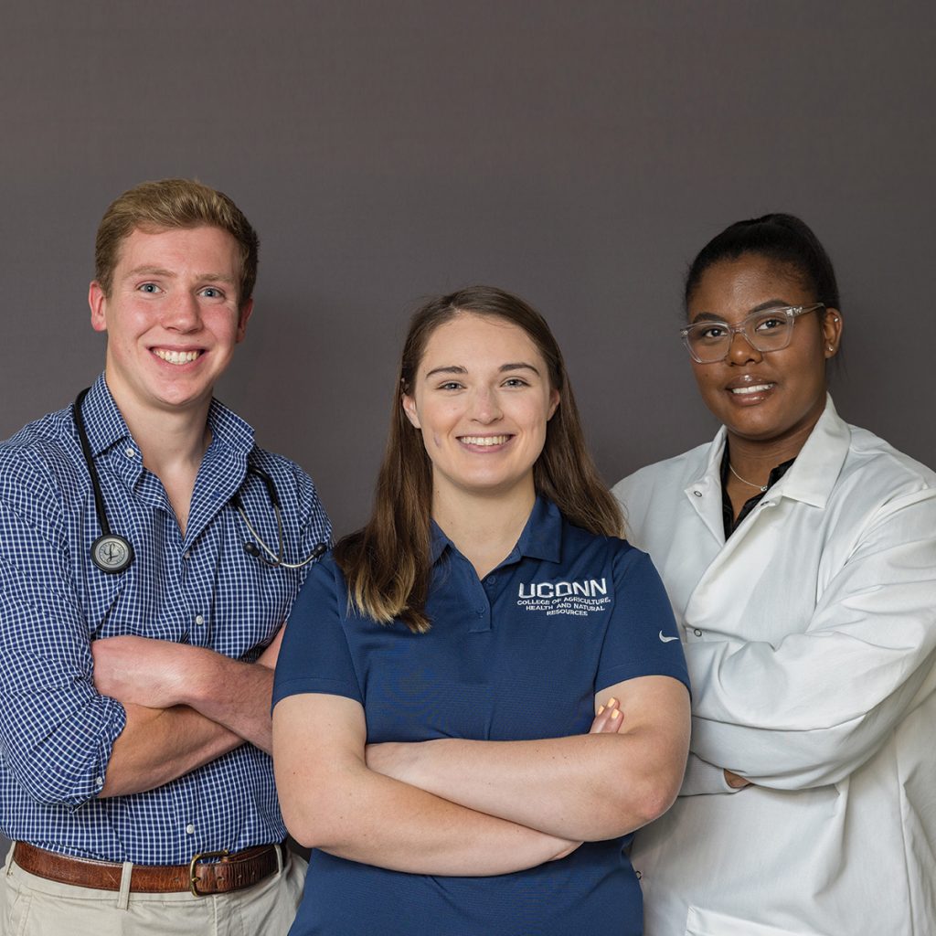 three students posing for Impacts Magazine cover