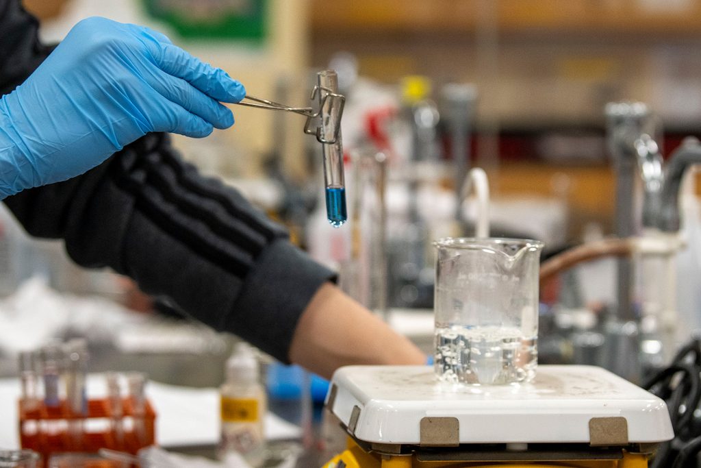 placing a beaker into boiling water