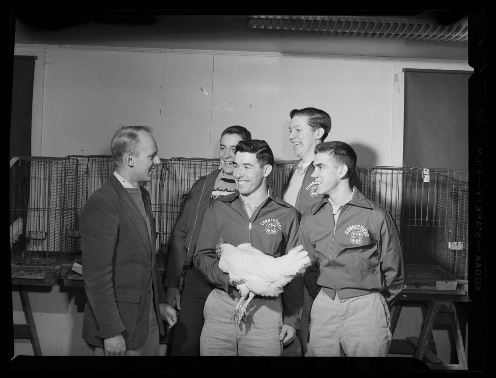 historical - group posing with a chicken