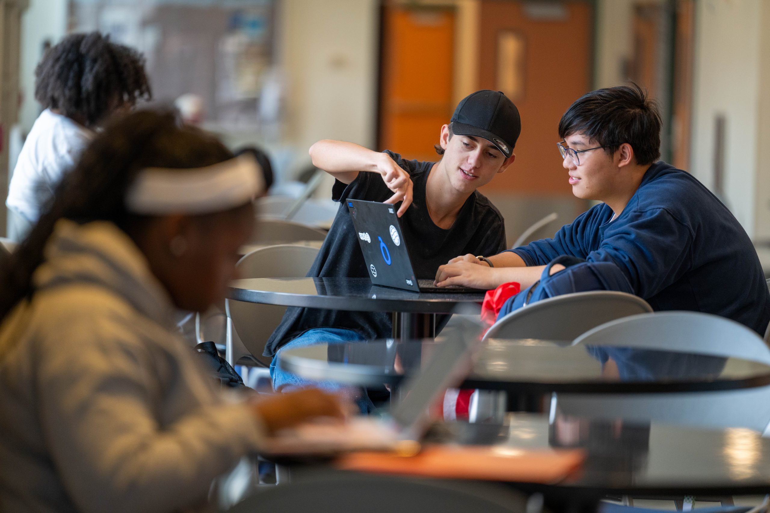 two students looking at a laptop