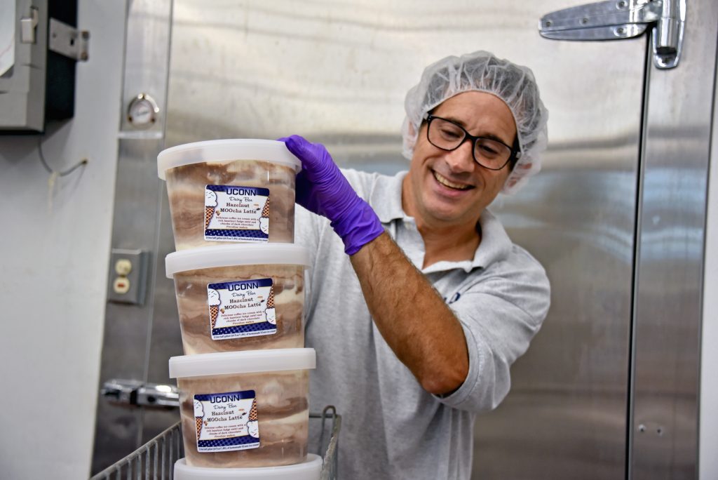 carrying a stack of ice cream pints
