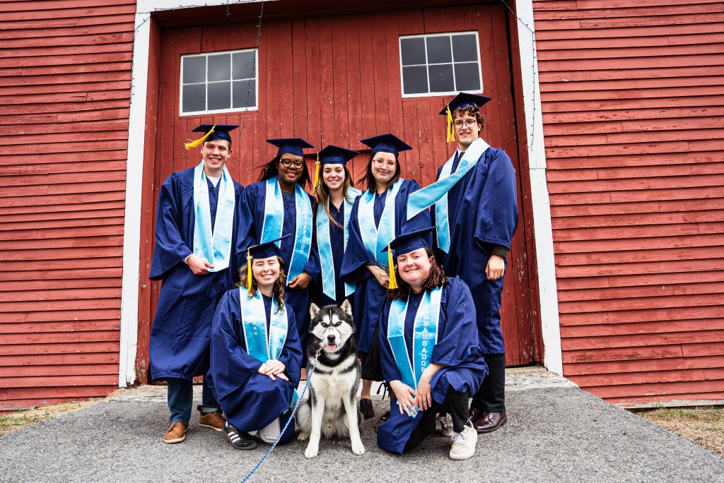 graduates and jonathan XV in front of red barn