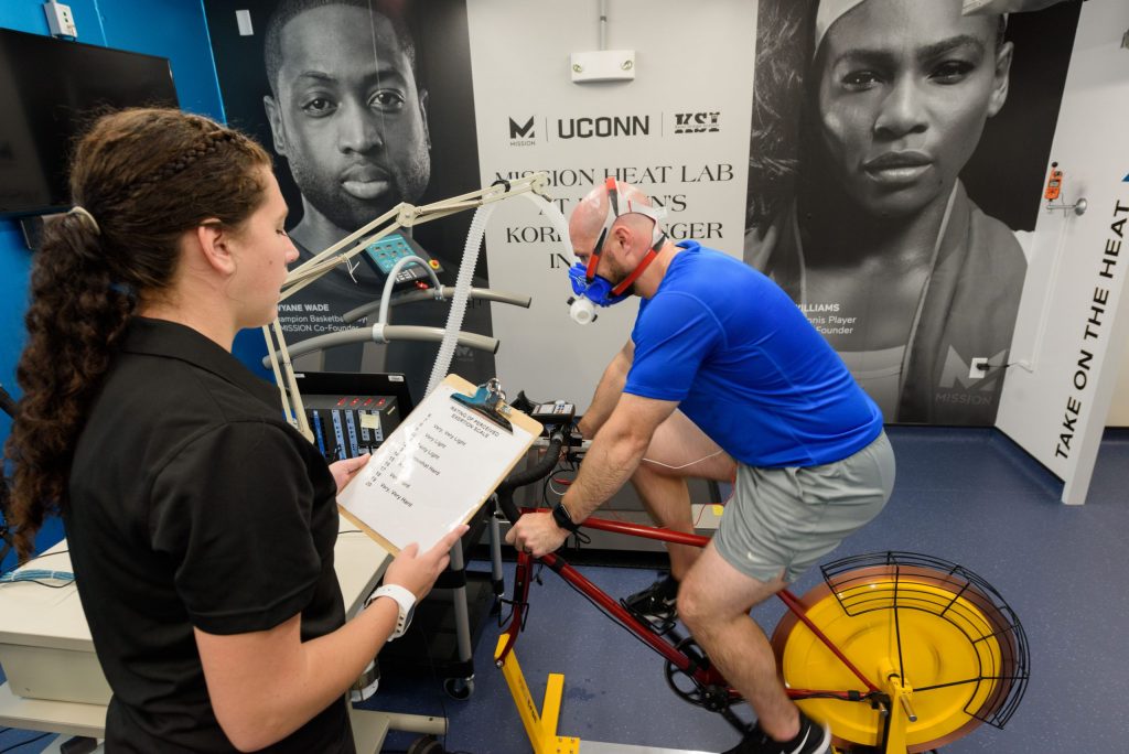 researcher with man on exercise bike