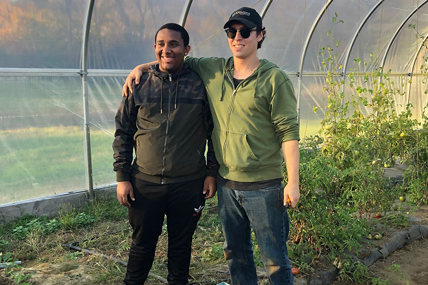 posing in a greenhouse