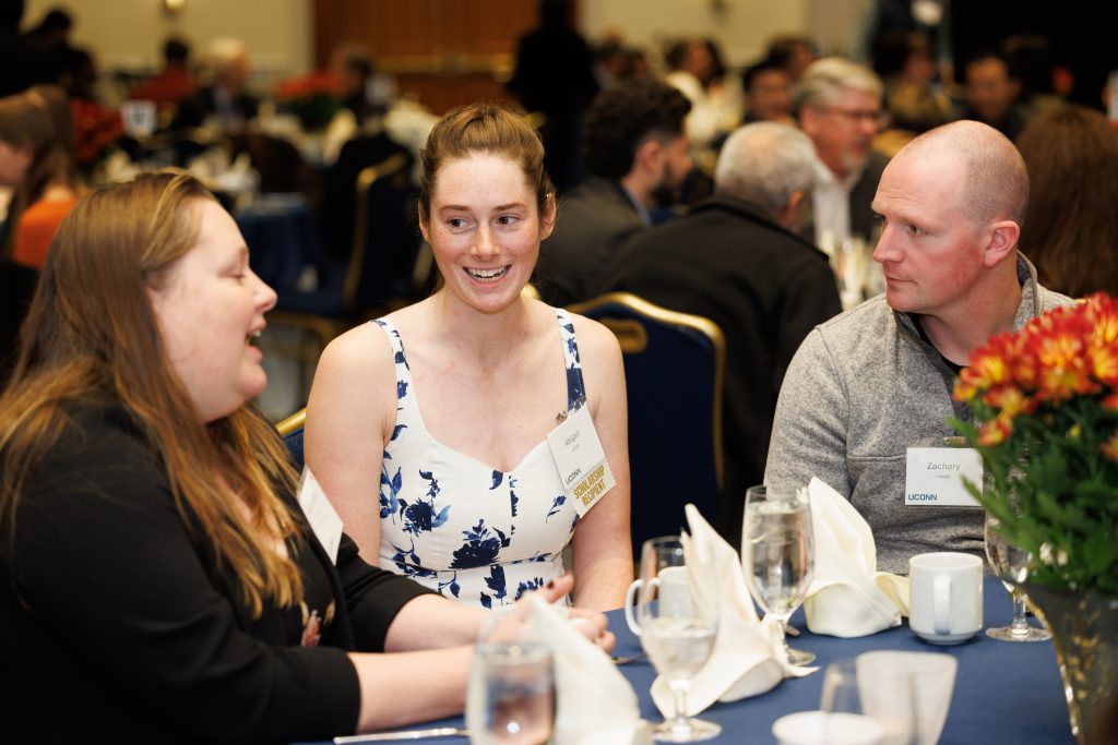 students and faculty at their table