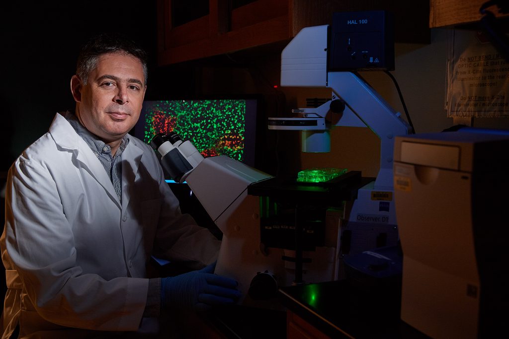 scientist at a microscope