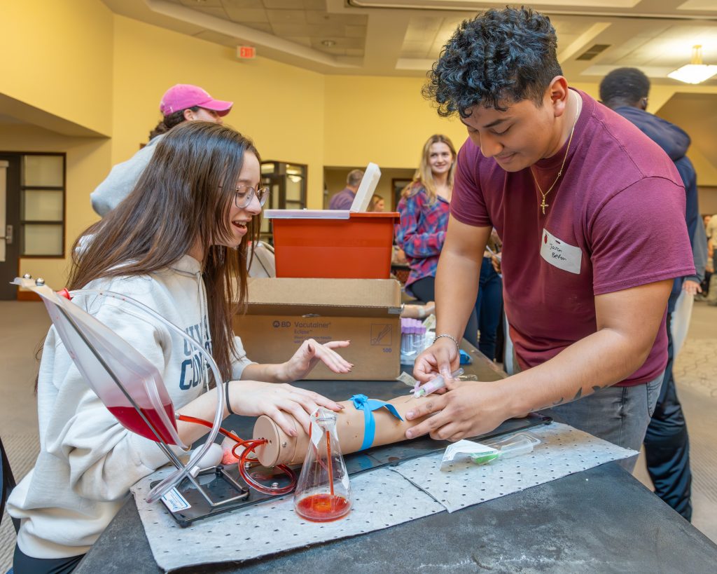 health students working on a dummy